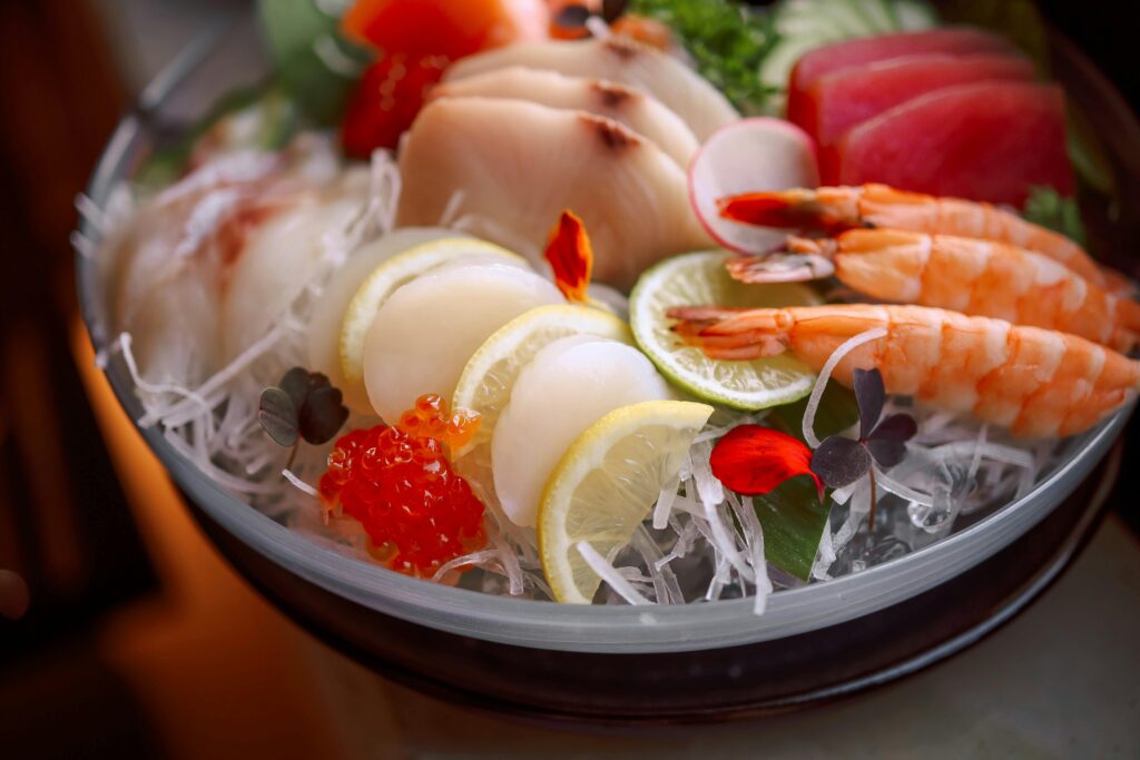 A vibrant seafood platter featuring fresh sashimi slices, shrimp, and colorful garnishes.